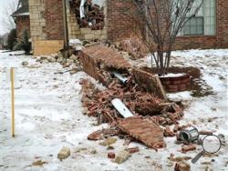 In this Dec. 29, 2015 photo, remains of a collapsed chimney rest on the ground outside a home in Edmond, Okla., following an earthquake. In Oklahoma the stronger and more frequent earthquakes have people worrying about the big one. In Oklahoma, now the country’s earthquake capital, people are talking nervously about the big one as man-made quakes get stronger, more frequent and closer to major population centers. (Doug Hoke/The Oklahoman via AP)