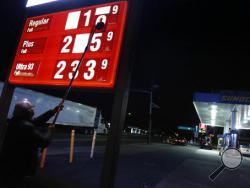 FILE - In this Tuesday, Nov. 1, 2016, file photo, Leon Balagula changes the price for the gasoline at his Sunoco station in the early morning, in Fort Lee, N.J. OPEC’s decision on Wednesday, Nov. 30, 2016, to cut production gave an immediate boost to oil prices, but the impact on consumers is likely to be more modest and gradual. (AP Photo/Seth Wenig, File)