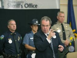 Douglas County District Attorney Rick Wesenberg, center, describes the events surrounding the officer involved shooting the morning of the mass murders at Umpqua Community College, during press conference in Roseburg, Ore. (Chris Pietsch/The Register-Guard via AP)