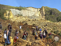 In this photo provided by the UNDP Papua New Guinea, villagers search through a landslide in Yambali village in the Highlands of Papua New Guinea, Sunday, May 26, 2024. The International Organization for Migration feared Sunday the death toll from a massive landslide is much worse than what authorities initially estimated. (Kafuri Yaro/UNDP Papua New Guinea via AP)