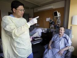 Thomas Manning, right, of Halifax, Mass. chats with Dr. Dicken Ko, director of the urology program at Massachusetts General Hospital, Wednesday, May 18, 2016, in Boston. Manning is the first man in the United States to undergo a penis transplant. Dr. Ko co-led the surgical transplant team. (AP Photo/Elise Amendola)