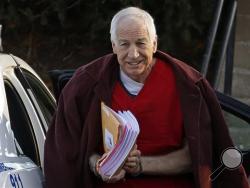 Jerry Sandusky arrives at the Centre County Courthouse for a post-sentencing hearing in Bellefonte, Pa. Penn State said Monday, Oct. 28, 2013 that it is paying $59.7 million to 26 young men over claims of child sexual abuse at the hands of Sandusky. The university said it had concluded negotiations that have lasted about a year. The school said 23 deals are fully signed and three are agreements in principle. (AP Photo/Gene J. Puskar, File)