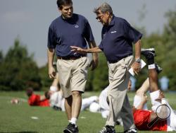 Penn State football coach Joe Paterno, right, walking with his son and quarterback coach Jay Paterno as players stretch out during practice in State College, Pa. Jay Paterno is the author of the book, "Paterno Legacy: Enduring Lessons from the Life and Death of My Father." Joe Paterno told his son the day after his firing that he hadn't informed the coaching staff about allegations Jerry Sandusky may be a child molester because he was unsure whether they were true, Jay Paterno writes. (AP)