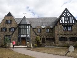 A reporter walks up to the front door of the Kappa Delta Rho fraternity house Tuesday, March 17, 2015, at Penn State University in State College.