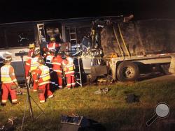 Firefighters from the White Deer Township and Milton fire departments work to extract victims from a crash between a Greyhound bus and a tractor-trailer early Wednesday, Oct. 9, 2013 in White Deer Township, Pa. Pennsylvania State Police said at least one person was killed in the crash and dozens were injured. (AP Photo/Milton Standard-Journal, Kevin Mertz)