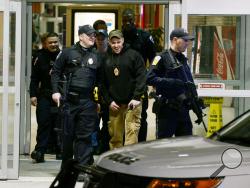 Police leave a secured Monroeville (Pa) Mall Saturday, Feb. 7, 2015, after a shooting in the mall. As many as three people were injured in the incident. It was unclear whether the shooter was captured or had escaped, said Monroeville Mayor Gregory Erosenko, who had only sketchy details shortly after the 7:45 p.m. shooting. He said his police chief was at the scene. (AP Photo/Pittsburgh Post-Gazette, Bill Wade)