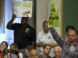 Audience members react after Philadelphia City Council passed a tax on sugary and diet beverages, in Philadelphia, Thursday, June 16, 2016. Philadelphia has become the first major American city with a soda tax despite a multimillion-dollar campaign by the beverage industry to block it. (AP Photo/Matt Rourke)