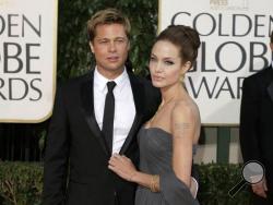 FILE - In this Jan. 15, 2007, file photo, actor Brad Pitt and actress Angelina Jolie arrive for the 64th Annual Golden Globe Awards in Beverly Hills, Calif. Angelina Jolie Pitt and estranged husband Brad Pitt have reached a custody agreement regarding their six children, according to a statement released by a representative of the actress Monday, Nov. 7, 2016. (AP Photo/Mark J. Terrill, File)
