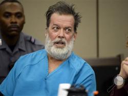 FILE - In this Dec. 9, 2015 file photo, Robert Lewis Dear, middle, talks during a court appearance in Colorado Springs, Colo. (Andy Cross/The Denver Post via AP, Pool, File