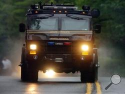 A Pennsylvania State Police vehicle speeds along Route 402 on Saturday, Sept. 13, 2014, near the scene where a Pennsylvania State Trooper was killed and another trooper was injured, during a shooting late Friday night at the state police barracks in Blooming Grove Township, Pa.(AP Photo/The Scranton Times-Tribune, Butch Comegys)