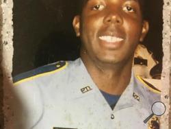 In this undated photo provided by Trenisha Jackson, her husband, Baton Rouge Police Officer Montrell Jackson poses for a photo. Montrell Jackson and two other Baton Rouge law enforcement officers investigating a report of a man with an assault rifle were killed Sunday, July 17, 2016, less than two weeks after a black man was fatally shot by police here in a confrontation that sparked nightly protests that reverberated nationwide. (Courtesy of Trenisha Jackson via AP)