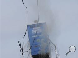 Parachutes slow down the descent of a 10-foot, 450 pound porta-potty, mounted on rocket motors, Saturday, Dec. 6, 2014, during rocket launches by Michiana Rocketry in a field in Three Oaks, Mich.(AP Photo/The Herald-Palladium, Don Campbell)