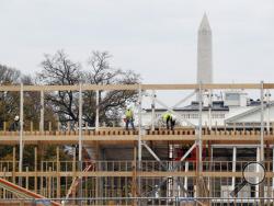 Construction continues on the presidential reviewing stand on Pennsylvania Avenue in Washington, Friday, Nov. 25, 2016, looking toward the White House and the Washington Monument. The reviewing stand is where then President Donald Trump will view the inaugural parade on Jan. 20, 2017. (AP Photo/Alex Brandon)