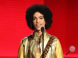 In this Nov. 22, 2015 file photo, Prince presents the award for favorite album - soul/R&B at the American Music Awards in Los Angeles. Prince, widely acclaimed as one of the most inventive and influential musicians of his era with hits including "Little Red Corvette," ''Let's Go Crazy" and "When Doves Cry," was found dead at his home on Thursday, April 21, 2016, in suburban Minneapolis, according to his publicist. He was 57. (Photo by Matt Sayles/Invision/AP, File)