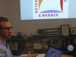 Greg Nemes, of the design firm Work-Shop, displays the new logo for a campaign to attract tourism and business to Rhode Island, during an interview with The Associated Press in The Design Office on Tuesday, March 29, 2016, in Providence, R.I. The state released the logo this week, created by Milton Glaser, whose past work includes the iconic "I Love NY" logo. (AP Photo/Michelle R. Smith)