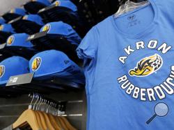 Akron RubberDucks logos show up on hat and shirt merchandise in the team shop before a minor league baseball game between Akron and Bowie. (AP Photo/Tony Dejak)