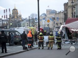 Russian Emergency Situations Ministry stand at the side of an explosion at a cafe in St. Petersburg, Russia, Sunday, April 2, 2023. An explosion tore through a cafe in the Russian city of St. Petersburg on Sunday, and preliminary reports suggested a prominent military blogger was killed and more than a dozen people were injured. (AP Photo)