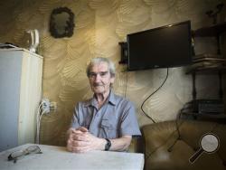 In this Thursday, Aug. 27, 2015 photo former Soviet missile defense forces officer Stanislav Petrov poses for a photo at his home in Fryazino, Moscow region, Russia. (AP Photo/Pavel Golovkin)