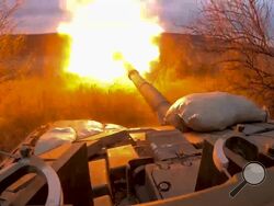 FILE - In this photo released by the Russian Defense Ministry on March 19, 2024, a Russian tank fires at Ukrainian troops from a position near the border with Ukraine in Russia’s Belgorod region. (Russian Defense Ministry Press Service via AP, File)