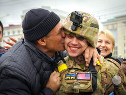 FILE - A Kherson resident kisses a Ukrainian soldier in central Kherson, Ukraine, Sunday, Nov. 13, 2022. Ukraine liberated Kherson more than one week ago, and the city’s streets are revived for the first time in many months. People no longer sit in their homes in fear of meeting the Russians. Instead, they gather in the city’s squares to recharge their phones, collect water and catch a connection to talk to their relatives. (AP Photo/Efrem Lukatsky, file)