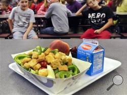 In this Tuesday, Sept. 11, 2012 file photo, a select healthy chicken salad school lunch, prepared under federal guidelines, sits on display at the cafeteria at Draper Middle School in Rotterdam, N.Y. After just one year, some schools across the nation are dropping out of what was touted as a healthier federal lunch program, complaining that so many students refused the meals packed with whole grains, fruits and vegetables that their cafeterias were losing money. (AP Photo/Hans Pennink, File)