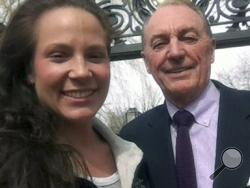 This photo taken and provided by Ali Luthman, left, of Worcester, Mass., shows her with Bryant University President Ronald Machtley on the school's campus in Smithfield, R.I. on Friday, April 18, 2104. Although Machtley, who is active on social media, loves posing for pictures with the students, the university has asked graduates to resist the urge to take a selfie with him when receiving their diploma this year.