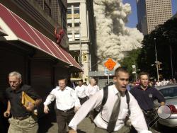 In this Sept. 11, 2001 file photo, people run from a collapsing World Trade Center tower in New York. For over a decade after the autumn of 2001, America, with its allies, has been at war against factions of Islamist militants and terrorists, including the Taliban and al-Qaida, as well as offshoots in Yemen, Somalia and elsewhere. (AP Photo/Suzanne Plunkett, File) 