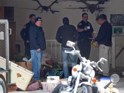 Authorities investigate a crime scene at a house in Pleasant Grove, Utah, Sunday, April 13, 2014. According to the Pleasant Grove Police Department, seven dead infants were found in the former home of Megan Huntsman, 39. Huntsman was booked into jail on six counts of murder. (AP Photo/Daily Herald, Mark Johnston)