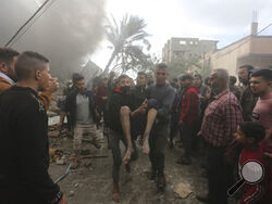 Palestinians evacuate survivors of an Israeli strike in Rafah, Gaza Strip, Thursday, Nov. 14, 2023. (AP Photo/Hatem Ali)