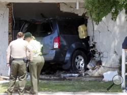 This image provided by Tony Cheval shows the scene of an accident Sunday April 20, 2014 where an alleged drunk driver ran into the home killing a 16-year-old girl in Palmdale, Calif. A Sheriff's Department spokesman said that 20-year-old Roberto Rodriguez of Palmdale allegedly crashed his Nissan Pathfinder into the corner of an apartment building at 3:50 a.m. Sunday. When deputies arrived they found the SUV embedded in the building and the girl dead inside. (AP Photo/Tony Cheval)
