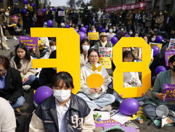 Participants hold signs representing International Women's Day during a rally in Seoul, South Korea, Wednesday, March 8, 2023. (AP Photo/Lee Jin-man)