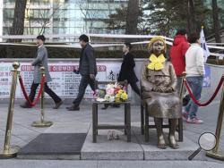 A statue symbolizing a wartime sex slave is displayed in front of the Japanese Embassy in Seoul, South Korea, Monday, Dec. 28, 2015. The foreign ministers of South Korea and Japan said Monday they had reached a deal meant to resolve a decades-long impasse over Korean women forced into Japanese military-run brothels during World War II, a potentially dramatic breakthrough between the Northeast Asian neighbors and rivals. (AP Photo/Ahn Young-joon)