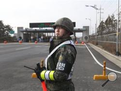 A South Korea Army soldier stands guard at the customs, immigration and quarantine office near the border village of Panmunjom, in Paju, South Korea, Thursday, Feb. 11, 2016. South Korean workers on Thursday began shutting down a jointly run industrial park in North Korea, a move that will end, at least temporarily, the Koreas' last major cooperation project as punishment over Pyongyang's recent rocket launch. (AP Photo/Ahn Young-joon)