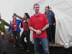 In this photo provided by the University of Hawaii, six scientists celebrate as they exit from their Mars simulation habitat on slopes of Mauna Loa on the Big Island, Hawaii, Sunday, Aug. 28, 2016. The scientists completed a yearlong Mars simulation in Hawaii on Sunday, where they lived in the dome in near isolation. (University of Hawaii via AP)