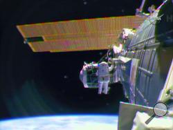 In this image from television astronaut Barry "Butch" Wilmore begins the spacewalk Saturday morning Feb. 21, 2015 to wire the International Space Station in preparation for the arrival in July of the international docking port for the Boeing and Space-X commercial crew vehicles. (AP Photo/NASA-TV)