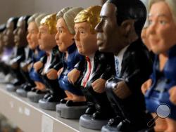 In this Monday, Oct. 3, 2016 photo, clay miniatures of presidential candidates Hillary Clinton, Donald Trump and U.S. President Barack Obama are displayed for sale at a shop in Barcelona, Spain. A curious Christmas tradition in the Spanish autonomous region of Catalonia depicts both candidates in a rather scatological situation. The miniatures called “Caganer”, depicts a person defecating, and traditionally symbolize fertilization and a source of luck and prosperity in the new year. (AP Photo/Manu Fernandez