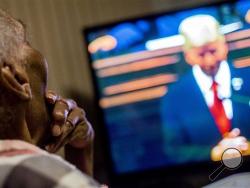 Flint resident Ollie Peterson, 87, strokes her chin while listening to Michigan Gov. Rick Snyder deliver his State of the State address on television Tuesday, Jan. 19, 2016, at their home in Flint. Peterson watched the governor speak with her husband David, 89, in hopes to hear his plan for resolving the Flint water crisis. (Jake May/The Flint Journal-MLive.com via AP)