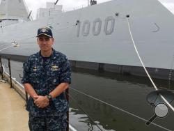 Capt. James Kirk, skipper of the future USS Zumwalt, stands in front of the destroyer at Bath Iron Works on Tuesday, Sept. 6, 2016, in Bath, Maine. The ship is due to depart the shipyard on Wednesday to be commissioned in Baltimore. (AP Photo/David Sharp)