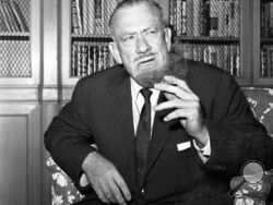 FILE - John Steinbeck talks to media in the office of his publisher in New York on Oct. 25, 1962. (AP Photo/Anthony Camerano, File)