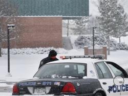 A police cruiser blocks the entrance to Standley Lake HIgh School, where classes were cancelled after an apparent suicide attempt by a student, in Westminster, Colo., Monday, Jan. 27, 2014. Police say a 16-year-old boy was critically injured after setting himself on fire at the suburban Denver high school. (AP Photo/Brennan Linsley)