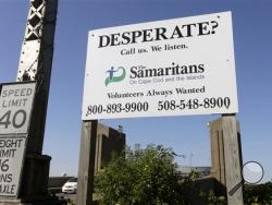 In this Thursday, Oct. 8, 2015 photo, a Samaritans sign is posted near the Bourne Bridge, in Bourne, Mass. For decades the Samaritans have offered phone counseling to the desperate and distraught. But increasingly the group is turning to text messaging to engage with young people. (AP Photo/Steven Senne)