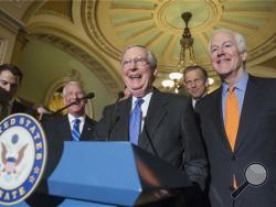 Senate Majority Leader Mitch McConnell of Ky., center, joined by, from second for left are, Sen. Roger Wicker, R-Miss., Sen. John Thune, R-S.D., and Senate Majority Whip John Cornyn of Texas, laughs while meeting with reporters on Capitol Hill in Washington, Tuesday, Feb. 23, 2016, following a closed-door policy meeting. (AP Photo/J. Scott Applewhite)