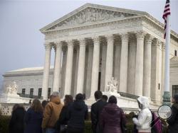 People wait in line outside the Supreme Court in Washington, Friday, Feb. 19, 2016, to pay their respects to Justice Antonin Scalia who is lying in repose in the Great Hall. (AP Photo/Evan Vucci)