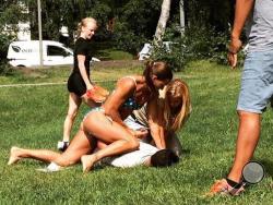 In this photo provided by Jenny Kitsune Adolffson Swedish police officer Mikaela Kellner is pinning a man to the ground who is suspected to have stolen a friend's mobile phone as she said, in Stockholm Sweden, Wednesday, July 27, 2016. She was off duty and wearing a bikini but that didn't stop her from apprehending the man. (Jenny Kitsune Adolfsson via AP)