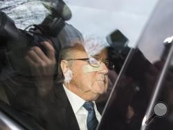 FIFA President Sepp Blatter arrives in a car at the FIFA headquarters Thursday morning, Dec. 17. (Walter Bieri/Keystone via AP)