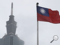 FILE - A Taiwan national flag flutters near the Taipei 101 building at the National Dr. Sun Yat-Sen Memorial Hall in Taipei, Taiwan, May 7, 2023. (AP Photo/Chiang Ying-ying, File)