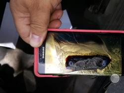 This Friday, Oct. 7, 2016, photo provided by Andrew Zuis, of Farmington, Minn., shows the replacement Samsung Galaxy Note 7 phone belonging to his 13-year-old daughter Abby, that melted in her hand earlier in the day. "She's done with Note 7s right now," Zuis said of his daughter. Reports of more replacement phones catching fire are trickling in, and the South Korean tech giant faces more scrutiny after earlier criticism for being slow to react and sending confusing signals in the first days of the recall. 
