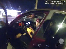 FILE - In this image taken from Sunday, Oct. 2, 2022, police body camera video and released by the San Antonio Police Department, Erik Cantu looks toward San Antonio Police Officer James Brennand while holding a hamburger in a fast food restaurant parking lot as the officer opens the car door in San Antonio, Texas. Brennand opened fire several times, wounding the unarmed teenager as he drove away. Brennand was fired after the shooting, and on Tuesday, Oct. 11 he was charged in connection with the shooting o