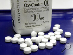 FILE - OxyContin pills are arranged for a photo at a pharmacy in Montpelier, Vt., Feb. 19, 2013. The Biden administration is moving to require patients to see a doctor in person before getting drugs to treat attention deficit disorders or addictive painkillers, toughening access to the medications against the backdrop of a deepening opioid crisis. (AP Photo/Toby Talbot, File)