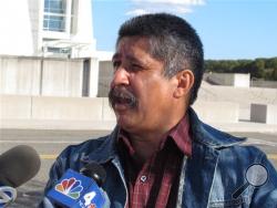 Albaro Zea speaks to reporters outside the U.S. District Courthouse in Central Islip, N.Y., following the arraignment of his son Marcos Alonzo Zea, on Friday, Oct. 18, 2013. The younger Zea was ordered held without bail after pleading not guilty to charges that he sought to join an al-Qaida group in Yemen.(AP Photo/Frank Eltman)